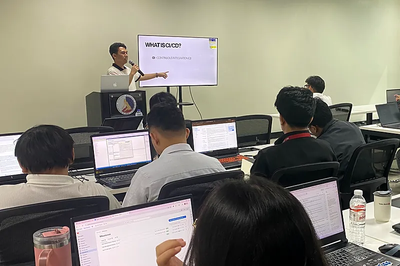 Anthony explaining what CI/CD is to government trainees at a DICT workshop.